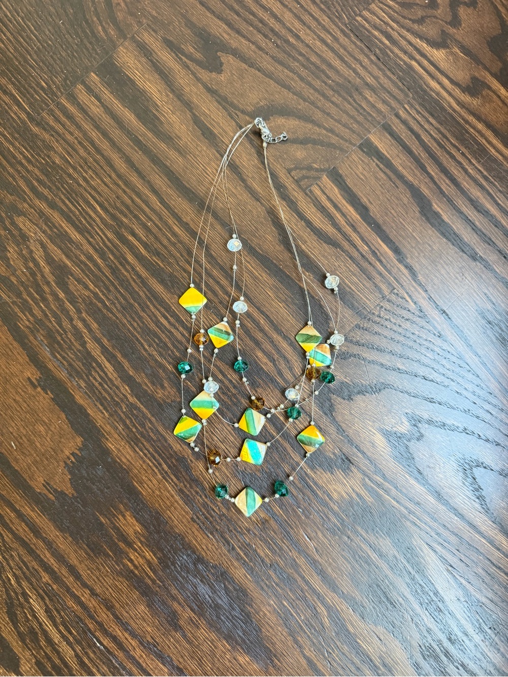 Multi-strand wire necklace featuring striped square beads